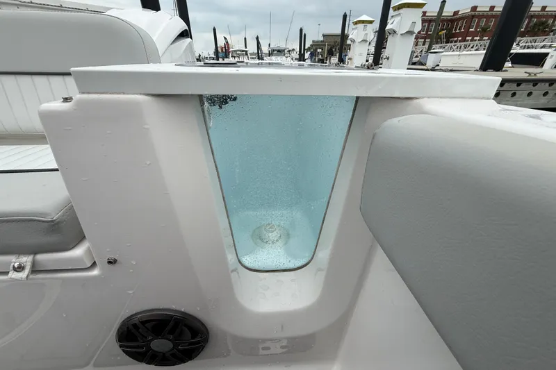 Slide: The Image of 2023 Sea Fox 248 Commander livewell with water, docked in marina. - 27