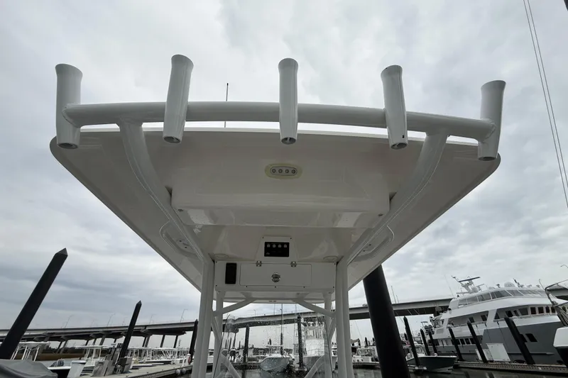 Slide: The Image of 2023 Sea Fox 248 Commander boat with rod holders, docked under cloudy skies. - 29