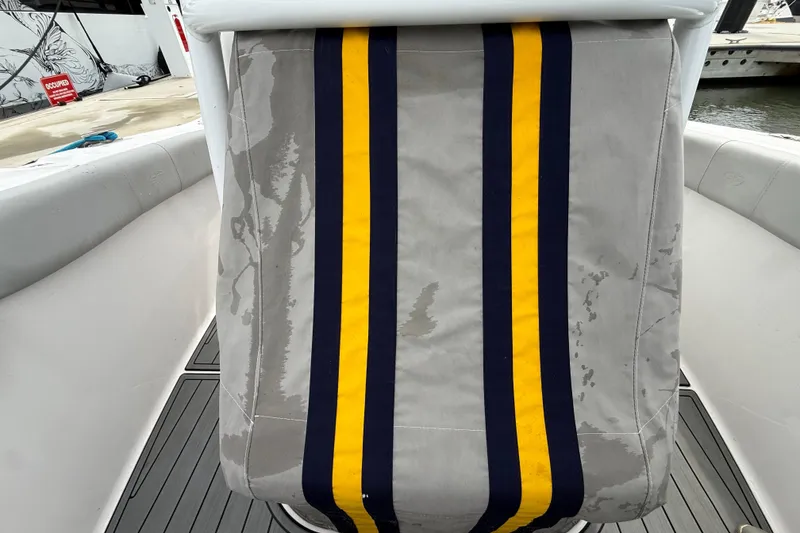 Slide: The Image of 2023 Sea Fox 248 Commander seat with yellow and navy stripes, dockside view. - 33