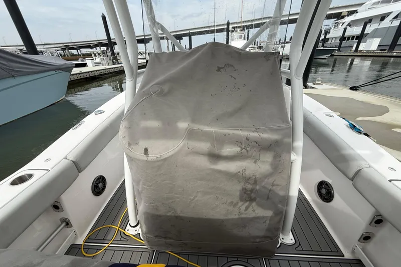 Slide: The Image of 2023 Sea Fox 248 Commander boat interior with covered console at marina. - 35