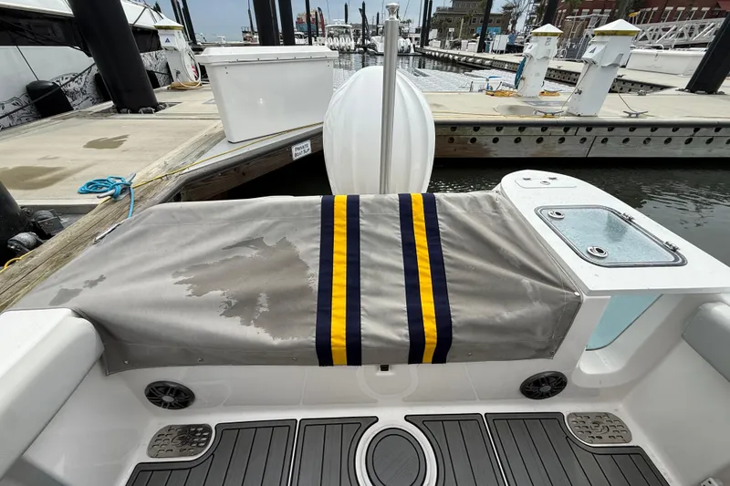 Slide: The Image of 2023 Sea Fox 248 Commander boat interior with striped cover and dock view. - 36