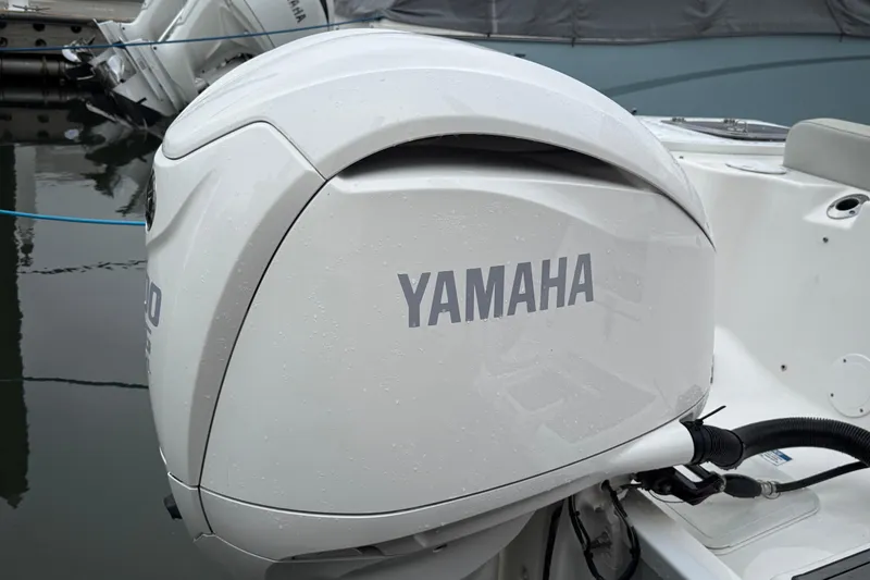Slide: The Image of 2023 Sea Fox 248 Commander with Yamaha outboard engine, docked on calm water. - 5