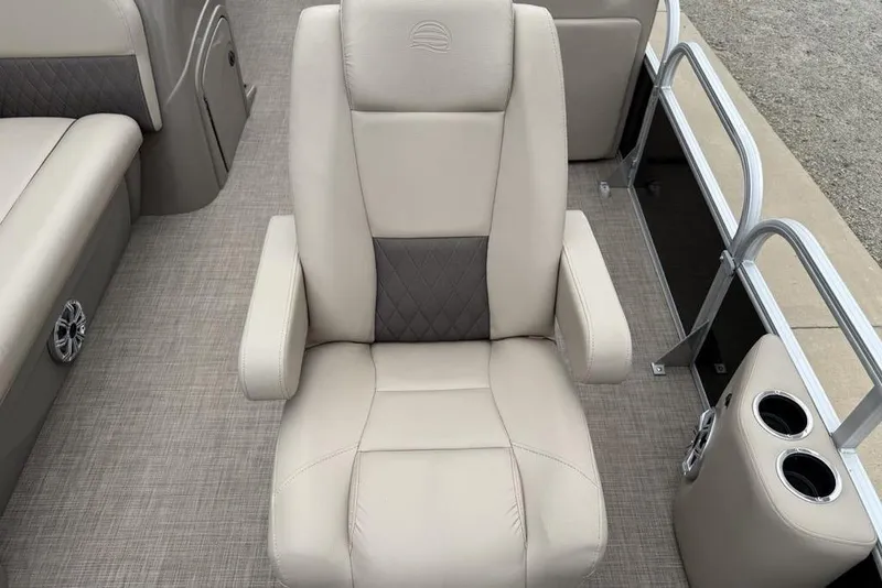 Slide: The Image of 2023 Sun Tracker SportFish 20 DLX boat seat with beige upholstery and cup holders. - 12