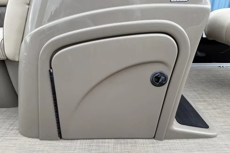 Slide: The Image of 2023 Sun Tracker SportFish 20 DLX storage compartment with beige finish and secure latch. - 13