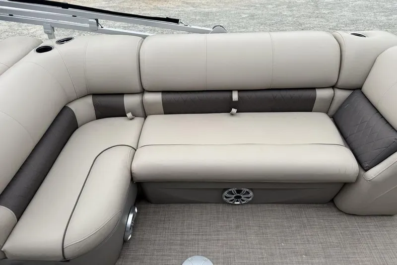 Slide: The Image of 2023 Sun Tracker SportFish 20 DLX boat interior with beige and gray seating. - 14