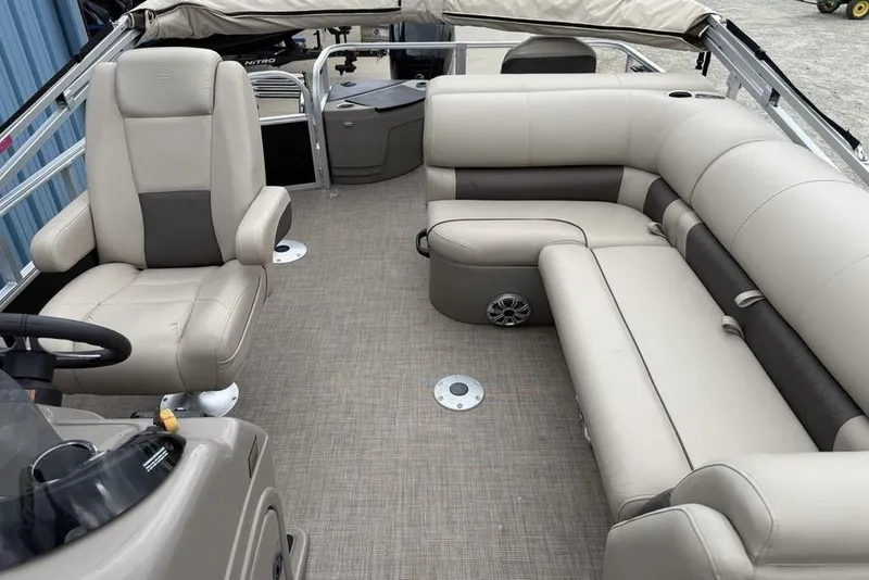 Slide: The Image of 2023 Sun Tracker SportFish 20 DLX pontoon boat interior with beige seating and steering console. - 15