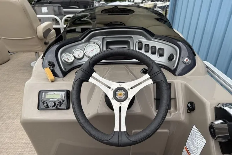 Slide: The Image of 2023 Sun Tracker SportFish 20 DLX dashboard with steering wheel and control panel. - 17