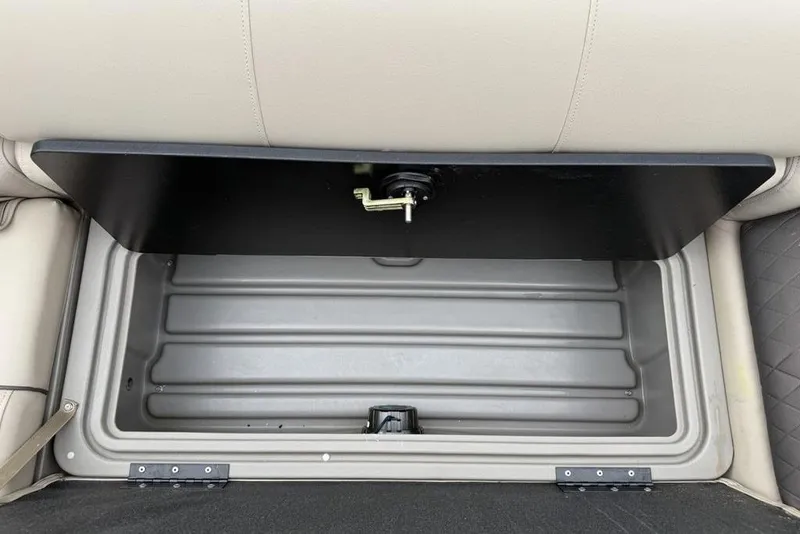 Slide: The Image of Storage compartment in 2023 Sun Tracker SportFish 20 DLX boat, featuring beige seating. - 19