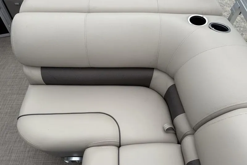 Slide: The Image of 2023 Sun Tracker SportFish 20 DLX boat seating with cup holders, beige and gray upholstery. - 20
