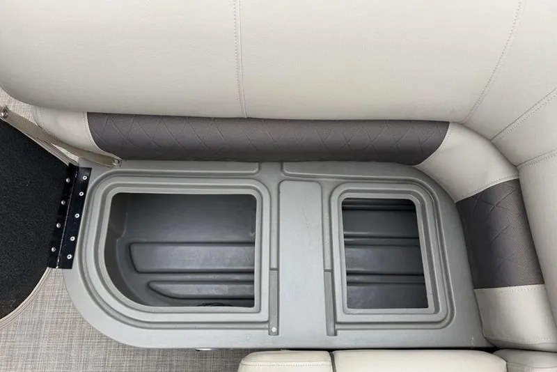 Slide: The Image of 2023 Sun Tracker SportFish 20 DLX boat seat storage compartment, gray and beige upholstery. - 22