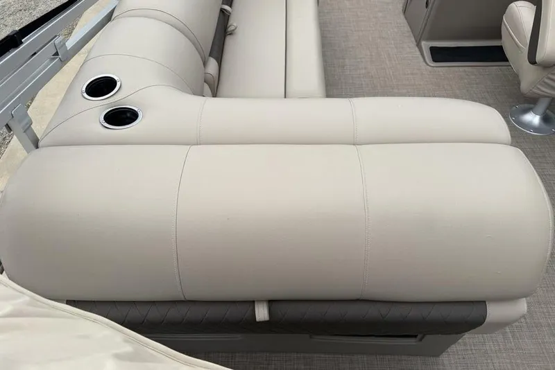 Slide: The Image of 2023 Sun Tracker SportFish 20 DLX boat interior with beige seating and cup holders. - 23