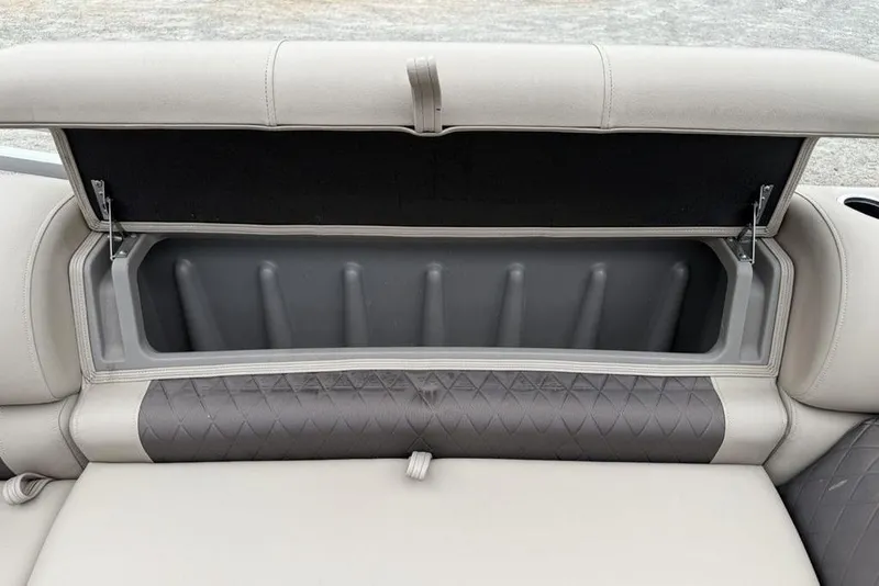 Slide: The Image of 2023 Sun Tracker SportFish 20 DLX boat seat storage compartment, open with quilted upholstery. - 24