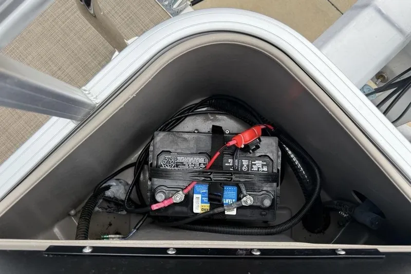 Slide: The Image of Battery compartment of 2023 Sun Tracker SportFish 20 DLX boat, featuring wiring and connections. - 27