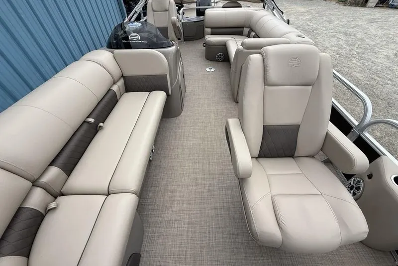Slide: The Image of 2023 Sun Tracker SportFish 20 DLX interior with beige seating and spacious layout. - 30