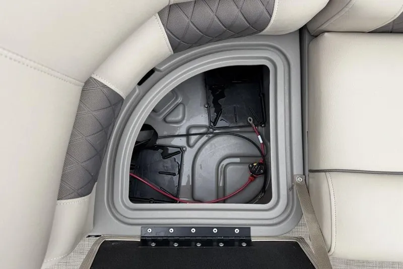 Slide: The Image of Storage compartment in 2023 Sun Tracker SportFish 20 DLX boat, featuring cushioned seating. - 7