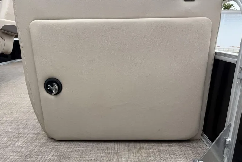 Slide: The Image of 2023 Sun Tracker SportFish 20 DLX boat interior storage compartment with beige upholstery. - 9