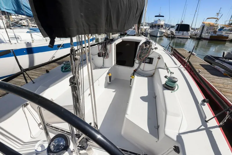 Slide: The Image of 2011 J Boats J 111 sailboat cockpit with steering wheel and marina view. - 10