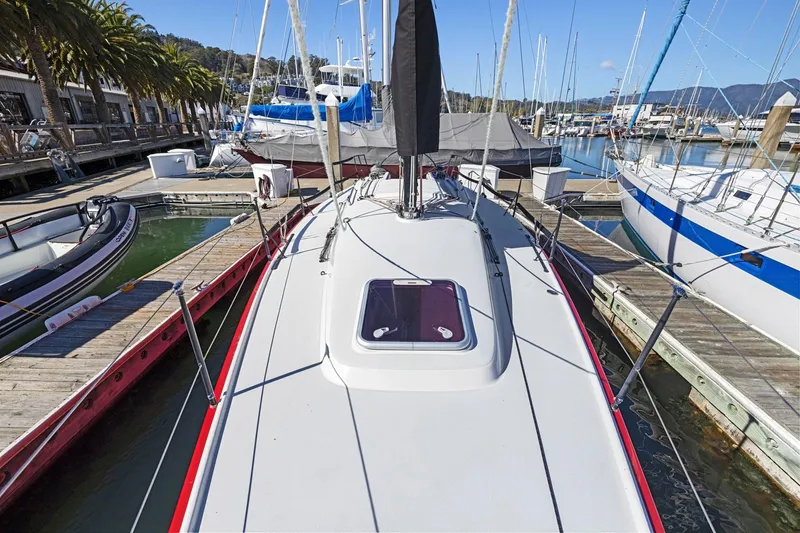 Slide: The Image of 2011 J Boats J 111 sailboat docked at a marina with clear skies. - 16