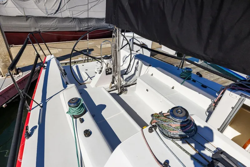 Slide: The Image of 2011 J Boats J 111 sailboat cockpit with ropes and winches, docked at marina. - 21