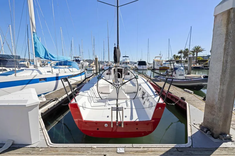 Slide: The Image of 2011 J Boats J 111 sailboat docked in a marina, surrounded by other vessels. - 3