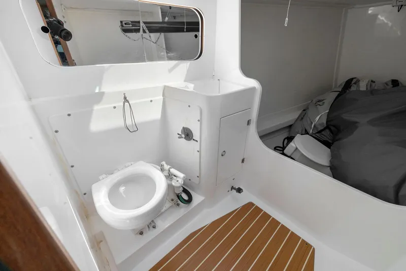 Slide: The Image of Interior of 2011 J Boats J 111 sailboat featuring compact marine toilet and storage area. - 35