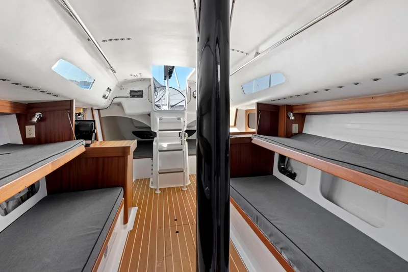 Slide: The Image of Interior of 2011 J Boats J 111 sailboat with wooden accents and gray seating. - 36