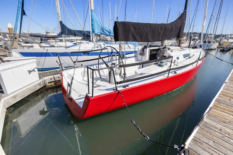 Slide: The Image of Red 2011 J Boats J 111 sailboat docked in marina, surrounded by other vessels. - 5