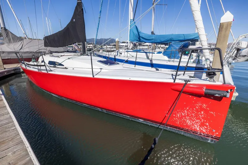 Slide: The Image of Red 2011 J Boats J 111 sailboat docked in marina, featuring sleek design and black sail. - 6