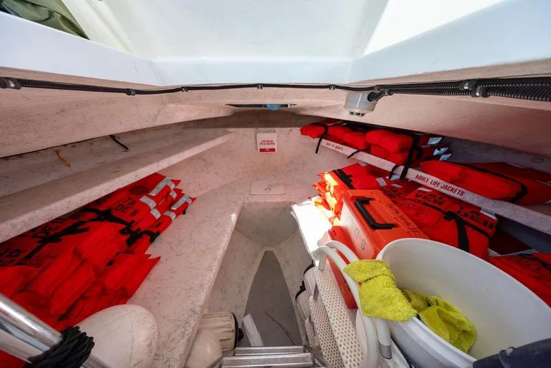 Slide: The Image of Interior of 2018 Seahawk Island Hopper boat with life jackets and safety equipment. - 12