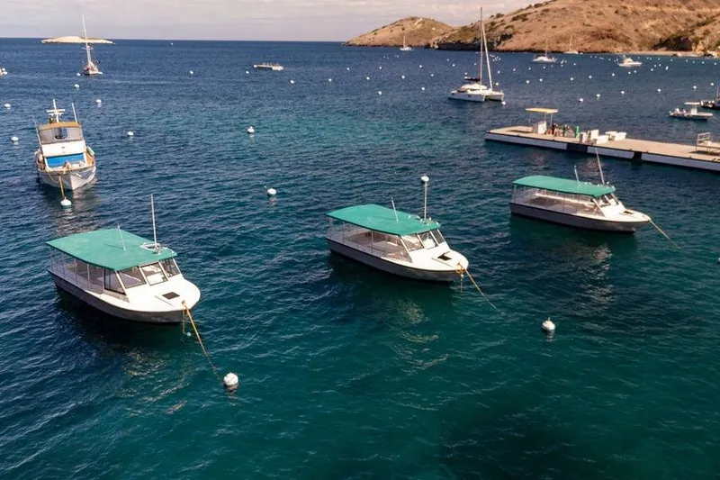 Slide: The Image of Boats anchored in a serene bay, featuring Seahawk Island Hopper models, 2018. - 15