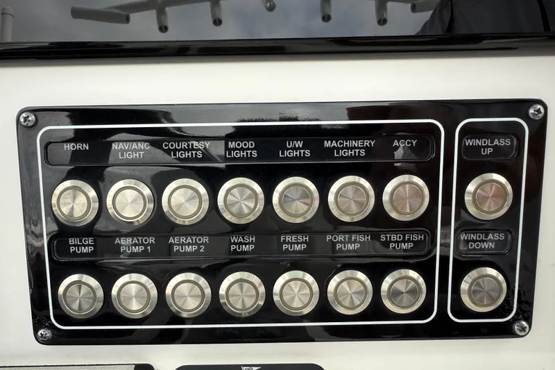 Slide: The Image of Control panel of a 2022 Sea Fox 288 Commander boat with labeled switches. - 13