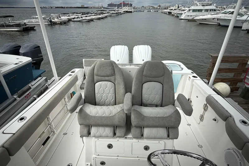Slide: The Image of 2022 Sea Fox 288 Commander boat interior with dual captain's chairs at marina. - 14