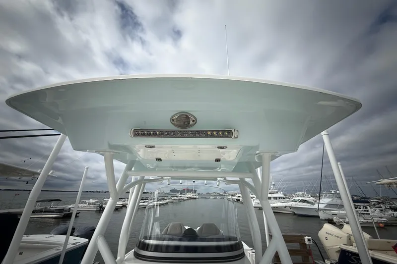 Slide: The Image of 2022 Sea Fox 288 Commander boat with T-top, docked at marina under cloudy sky. - 19