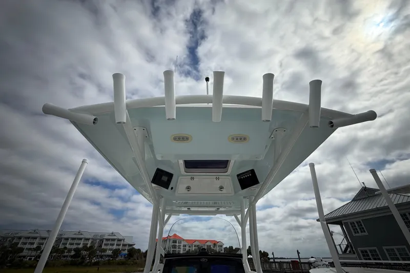 Slide: The Image of 2022 Sea Fox 288 Commander boat top view with rod holders under cloudy sky. - 20