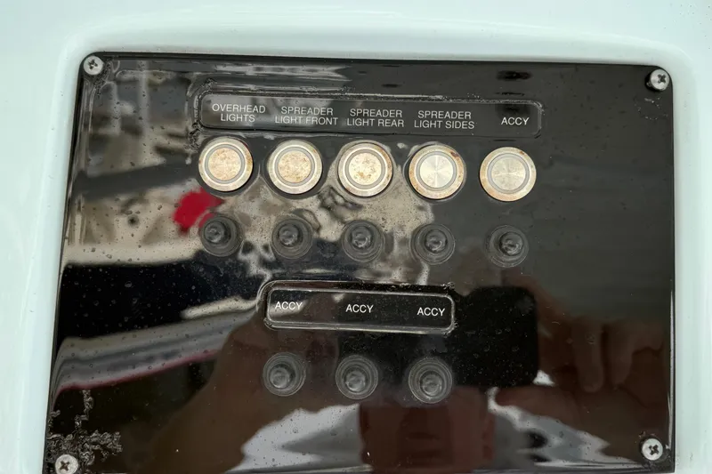 Slide: The Image of Control panel of a 2022 Sea Fox 288 Commander boat with labeled switches. - 22