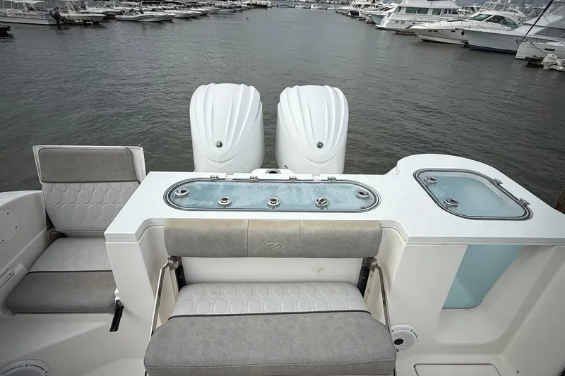 Slide: The Image of 2022 Sea Fox 288 Commander boat interior with dual engines and seating at marina. - 25