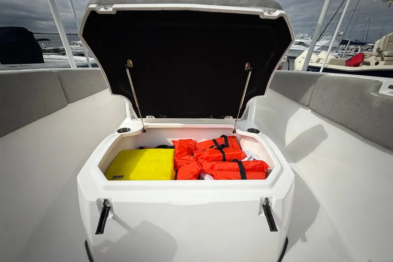 Slide: The Image of Open storage compartment on 2022 Sea Fox 288 Commander with life jackets inside. - 26