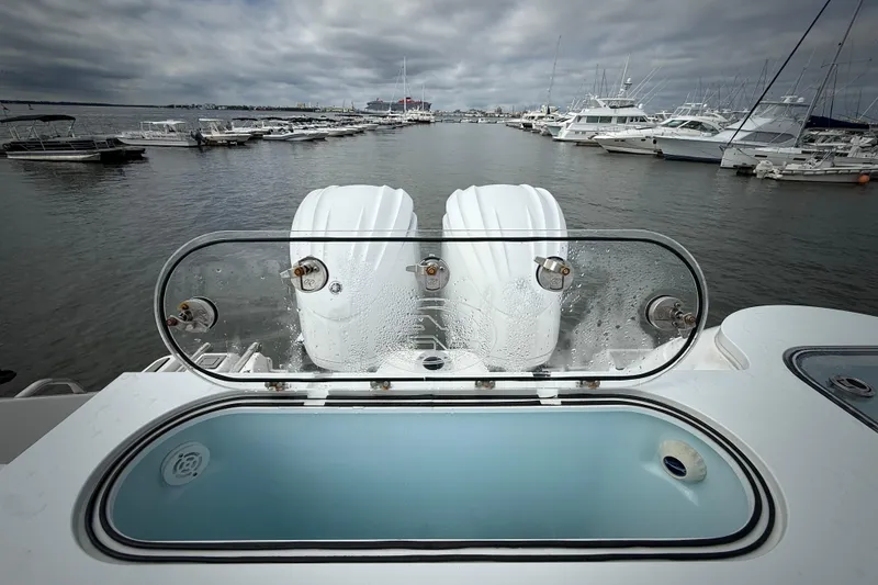 Slide: The Image of 2022 Sea Fox 288 Commander boat with twin engines at a marina, cloudy sky. - 27