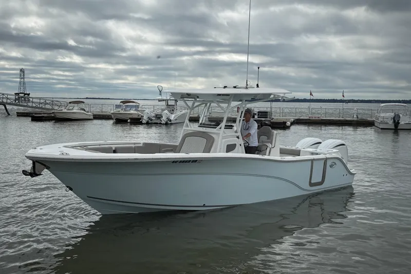 Slide: The Image of 2022 Sea Fox 288 Commander boat docked on a cloudy day at a marina. - 3