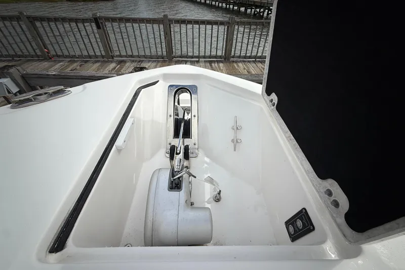 Slide: The Image of Anchor compartment of 2022 Sea Fox 288 Commander boat, open lid, dockside view. - 32
