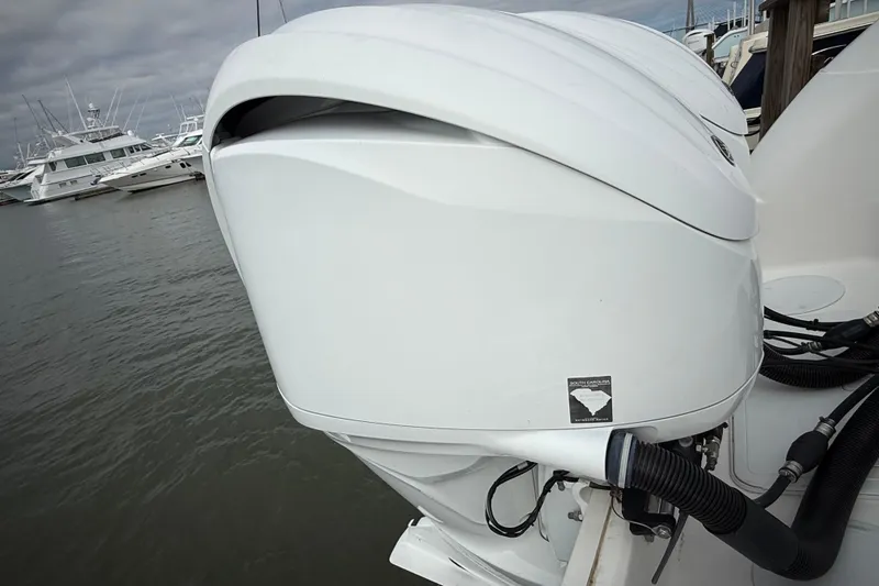 Slide: The Image of 2022 Sea Fox 288 Commander boat engine at marina, overcast sky. - 35