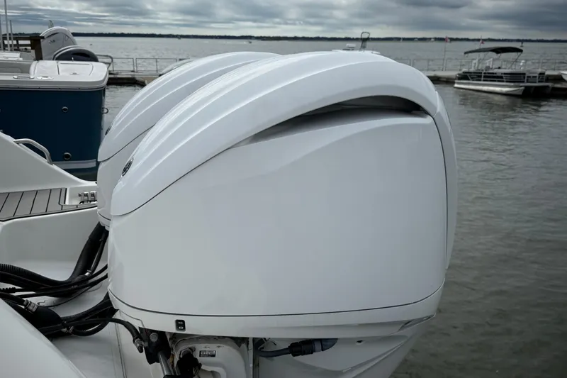 Slide: The Image of Twin outboard engines on a 2022 Sea Fox 288 Commander boat docked by the water. - 36