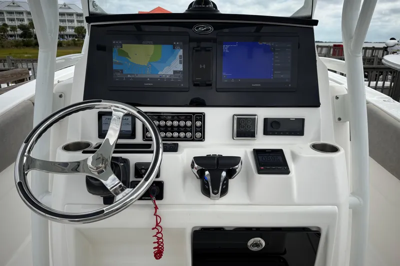 Slide: The Image of 2022 Sea Fox 288 Commander boat dashboard with steering wheel and navigation screens. - 6