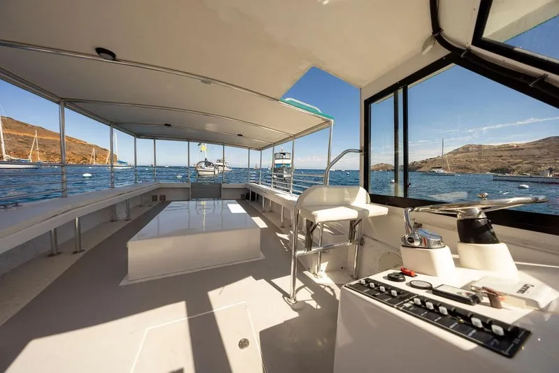 Slide: The Image of Interior view of 2019 Seahawk Island Hopper boat with ocean and hills in background. - 11