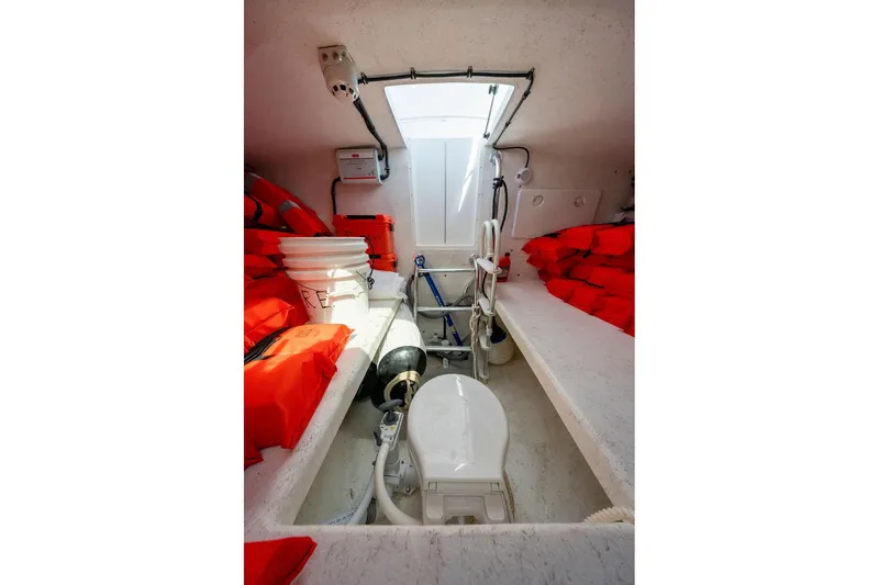 Slide: The Image of Interior of 2019 Seahawk Island Hopper boat with life jackets and marine toilet. - 12