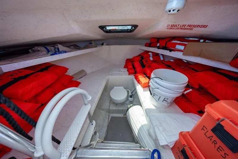 Slide: The Image of Interior of 2019 Seahawk Island Hopper with life preservers, flares, and safety equipment. - 13