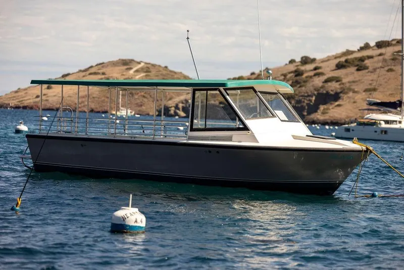 Slide: The Image of 2019 Seahawk Island Hopper boat moored in scenic coastal waters. - 5