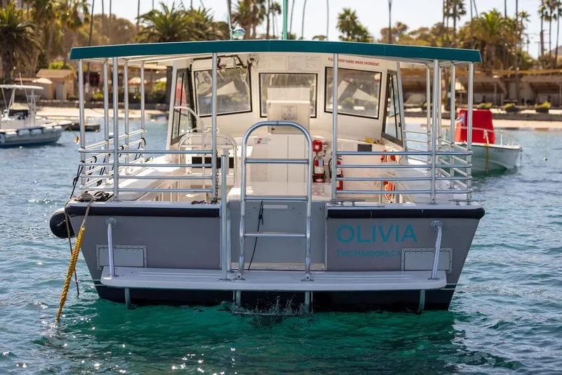 Slide: The Image of 2019 Seahawk Island Hopper boat named Olivia docked in a scenic harbor. - 8
