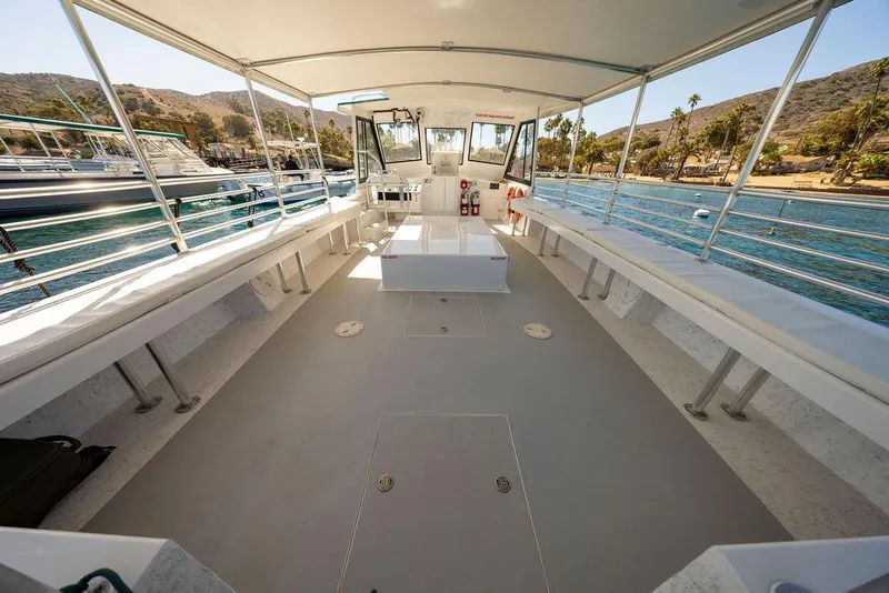 Slide: The Image of 2019 Seahawk Island Hopper boat interior with spacious seating and scenic coastal view. - 9