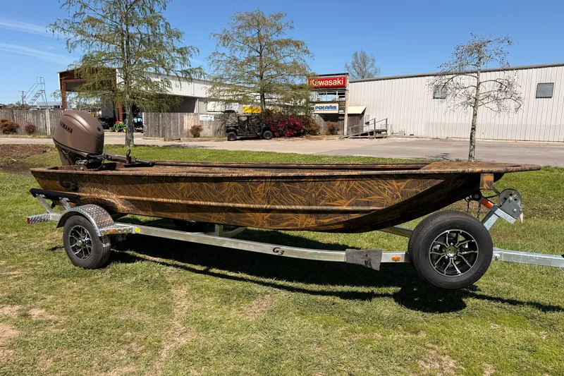 The Image of 2026 G3 Gator Tough 16 DK boat on trailer, outdoors, with Yamaha motor. - 0
